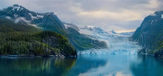 Coastal Alaska wilderness | Alaska Coastal Hunts Dramatic Alaskan coastal mountains meeting the sea under low clouds