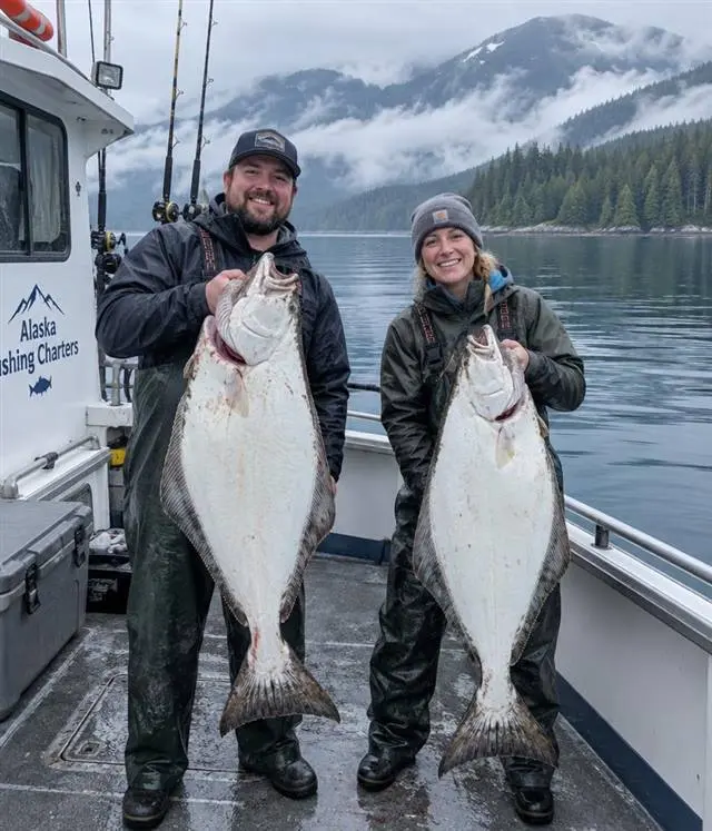 Halibut fishing in Alaska | Alaska Coastal Hunts Angler holding a large halibut on the deck of an Alaskan charter boat